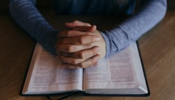 hands clasped on Jesus' model prayer